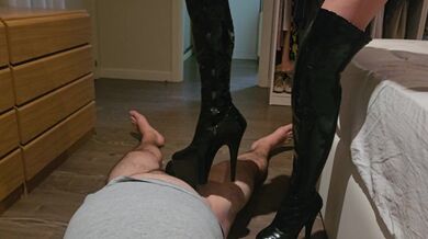 Milf che calpesta il cazzo del suo schiavo con gli stivali e usa le calze come preservativo