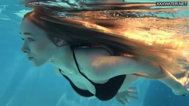 Giovane bionda dal corpo perfetto si diverte a nuotare nuda